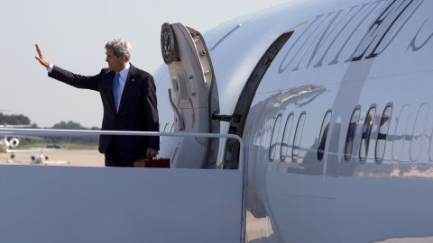 Secretary of State John Kerry waves Friday before boarding a plane to travel to Qatar.