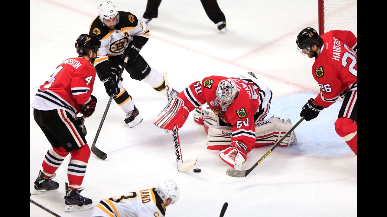 Corey Crawford of the Blackhawks makes a save against the Bruins.