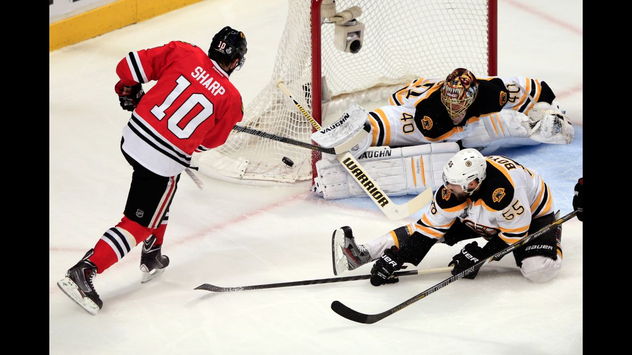Patrick Sharp of the Chicago Blackhawks takes a shot against Tuukka Rask of the Boston Bruins.