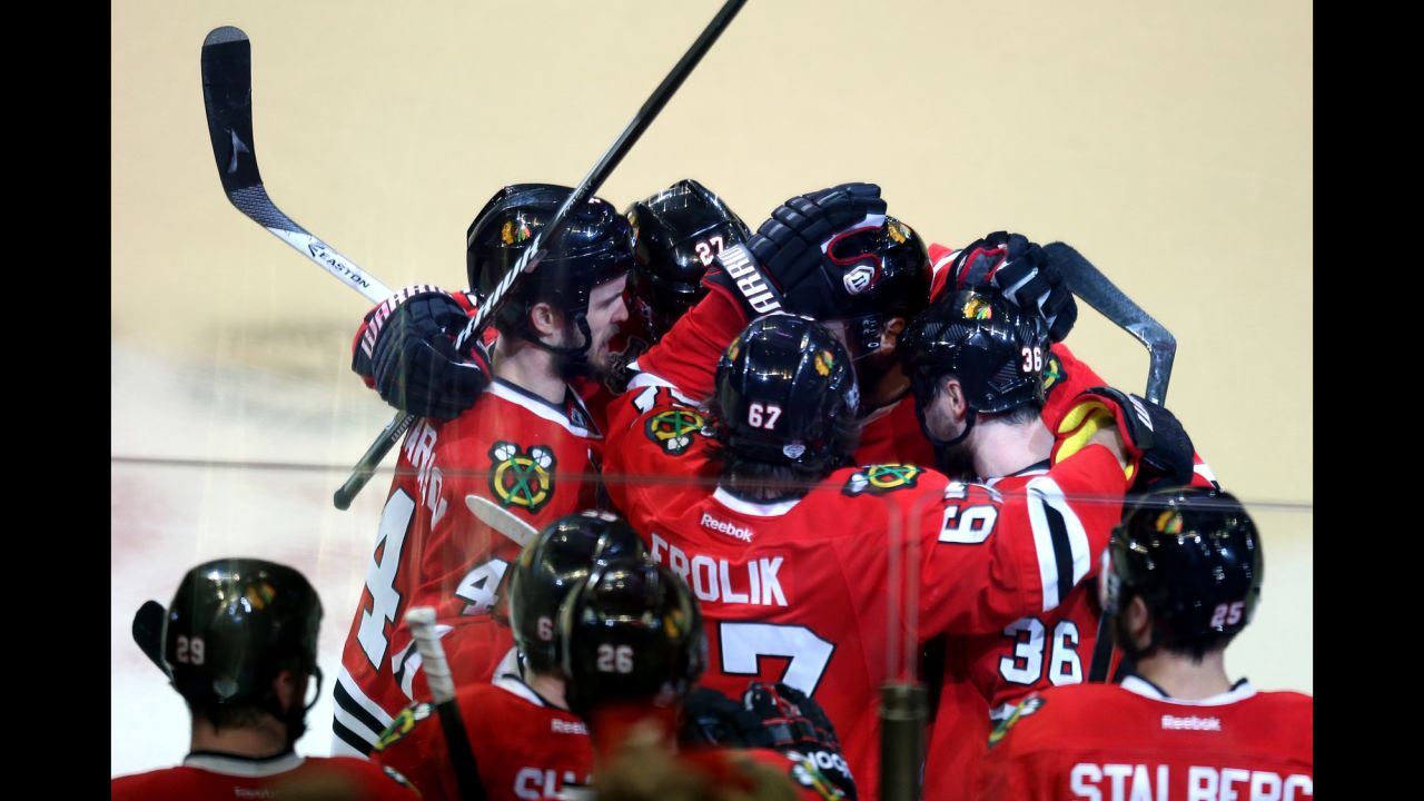 Members of the Chicago Blackhawks celebrate after defeating the Boston Bruins in Game Five of the 2013 NHL Stanley Cup Final at United Center on June 22, 2013 in Chicago, Illinois. The Blackhawks beat the Bruins 3-1, taking a 3-2 lead in the series. 