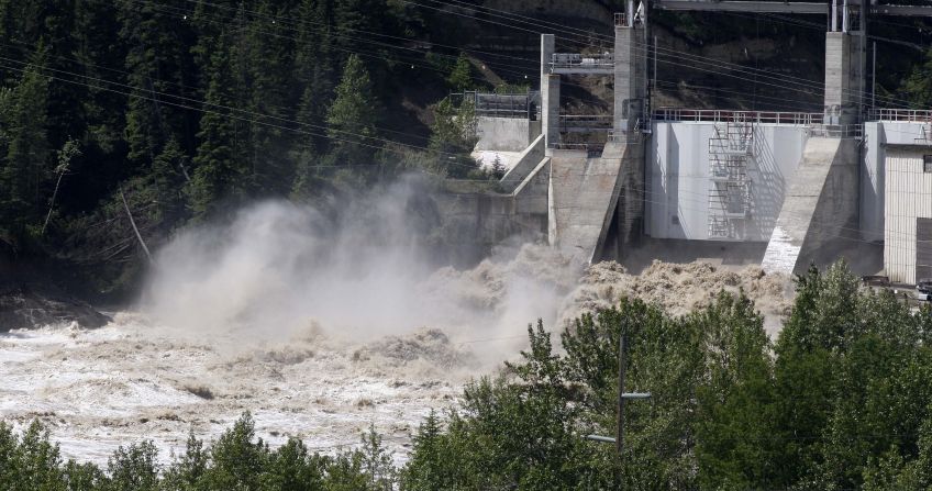 Bearspaw Dam opens the gates to release water into the flooded Bow River on June 22.