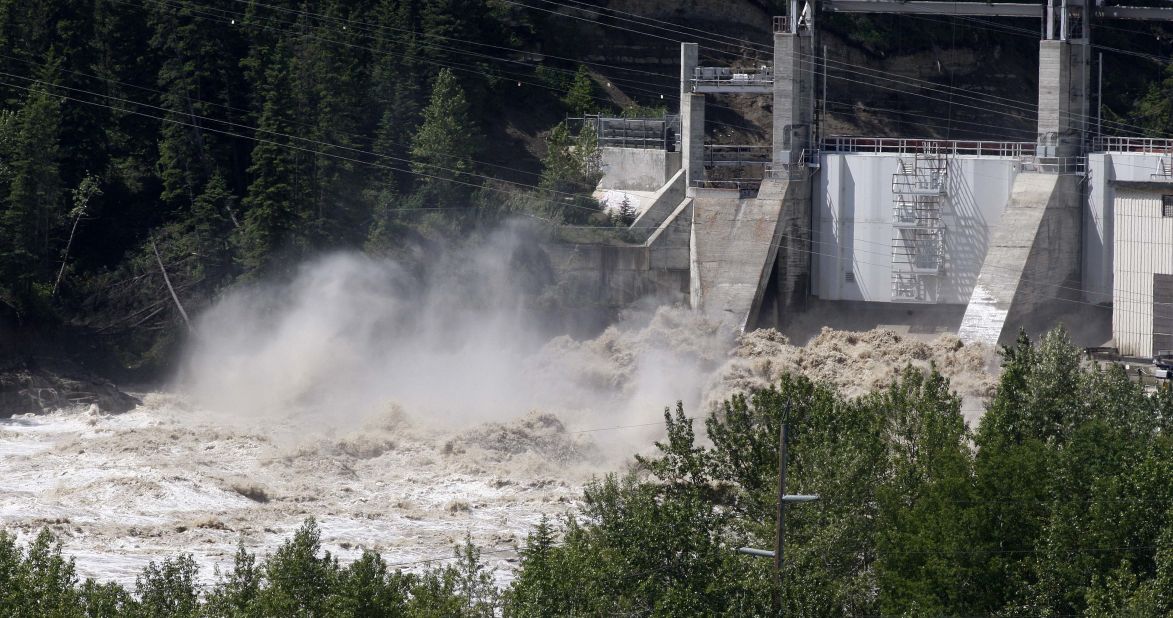 Bearspaw Dam opens the gates to release water into the flooded Bow River on June 22.