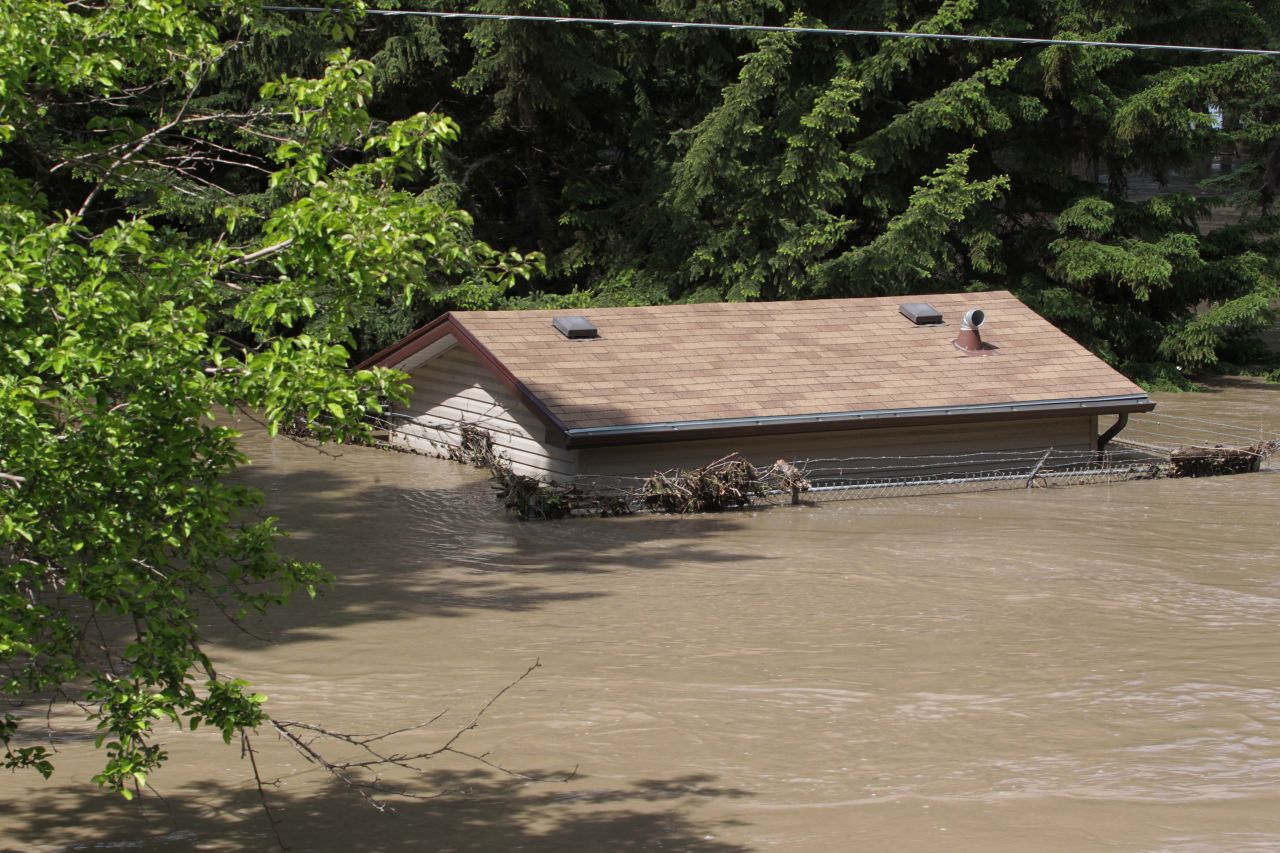 A house is submerged by floodwater at a park near the Bow River in Calgary on June 22.