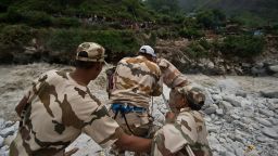 Indo-Tibetan Border Police (ITBP) personnel use a rope rescue system to transport stranded pilgrims across a river in Govind Ghat on June 23, 2013. Bad weather hampered rescue operations June 23 in northern India where up to 1,000 people are feared to have died in landslides and flash floods that have left pilgrims and tourists stranded without food or water.  AFP PHOTO/MANAN VATSYAYANA        (Photo credit should read MANAN VATSYAYANA/AFP/Getty Images)