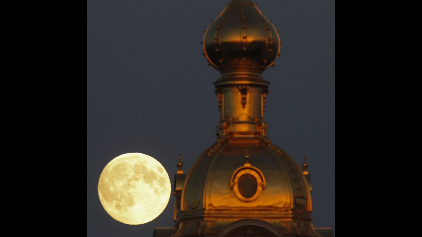 The moon rises behind the Peter and Paul Fortress in St. Petersburg, Russia, on June 22.