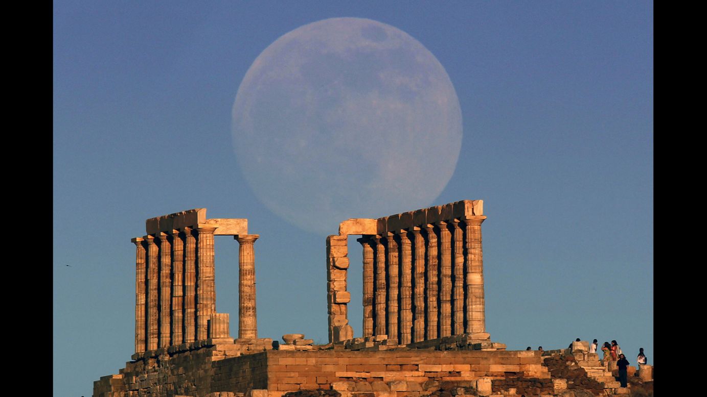 The Supermoon rises over the temple of Poseidon, the ancient Greek god of the seas, as the sun sets on Cape Sounion outside Athens, Greece, on June 22. 