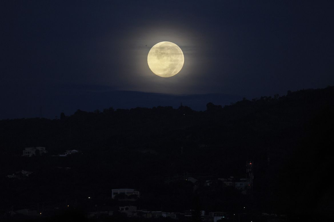 The moon lights the sky over San Salvador, the capital of El Salvador, on June 23.