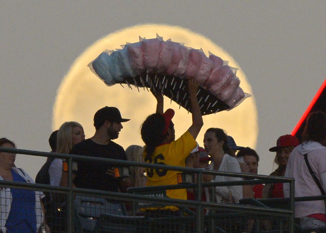 A cotton candy vendor weaves through the crowd during the Los Angeles Angels' baseball game against the Pittsburgh Pirates on Saturday, June 22.