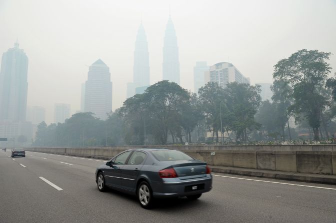 Malaysia is also heavily affected by the haze spreading from its neighbor, seen here in 2013 as motorists drive past the smog-enveloped Petronas Towers in Kuala Lumpur.