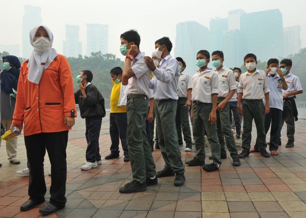 Students in Kuala Lumpur don masks during the 2013 haze -- a situation that led to states of emergency being declared in some areas of the country.