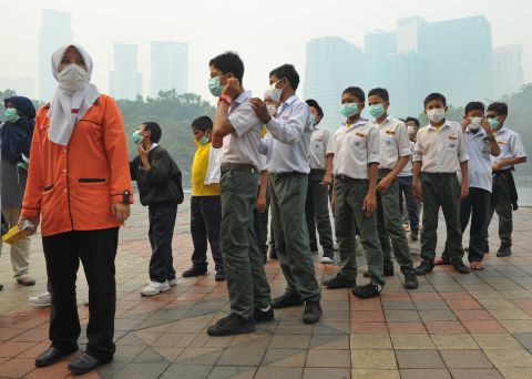 Students wear masks as haze shrouds Kuala Lumpur on June 23. Many schools in Malaysia were closed on Monday after air pollution caused by forest fires in Indonesia spiked to hazardous levels.