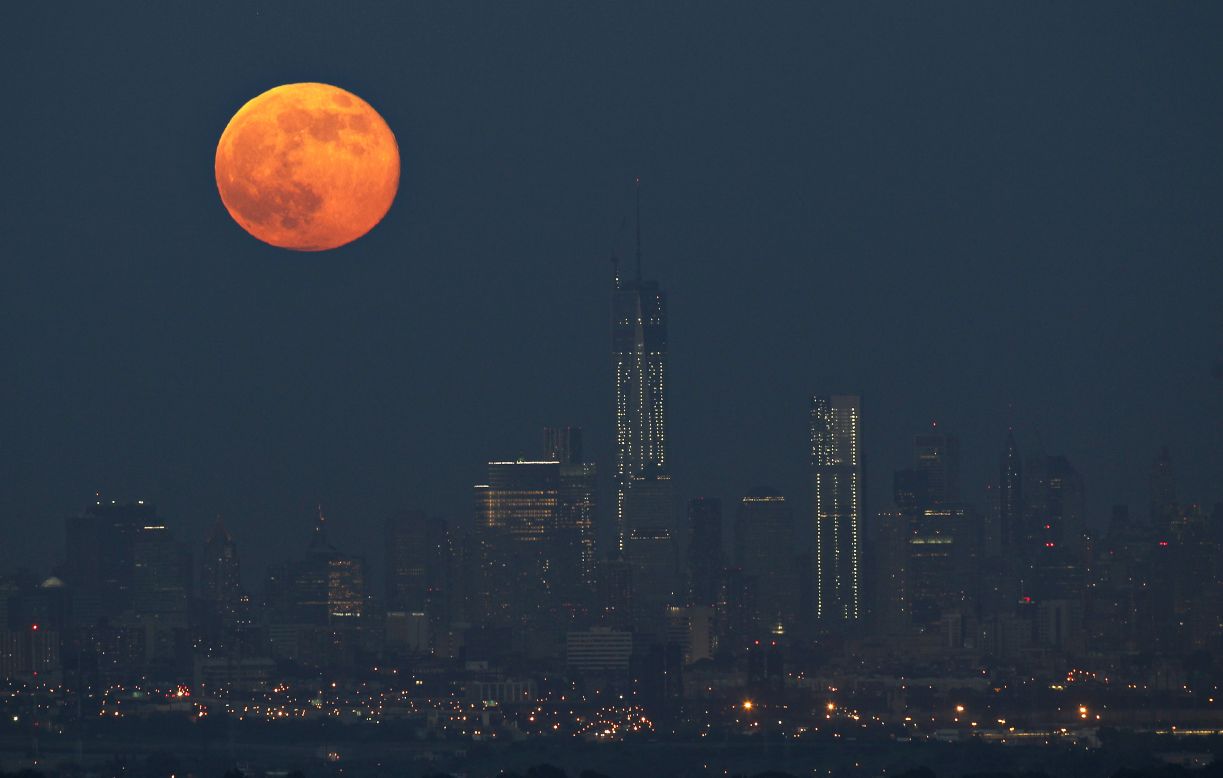The moon hangs over the Manhattan skyline on June 23.