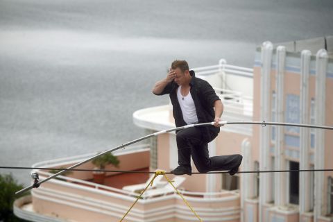 Wallenda wipes sweat from his forehead as he maneuvers across a 300-foot-long wire suspended 100 feet in the air between two towers of Puerto Rico's Conrad San Juan Condado Plaza Hotel in June 2011.