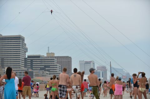 Crowds watch the daredevil during a 1,500-foot tightrope walk 100 feet above the beach in Atlantic City, New Jersey, in August 2012. 