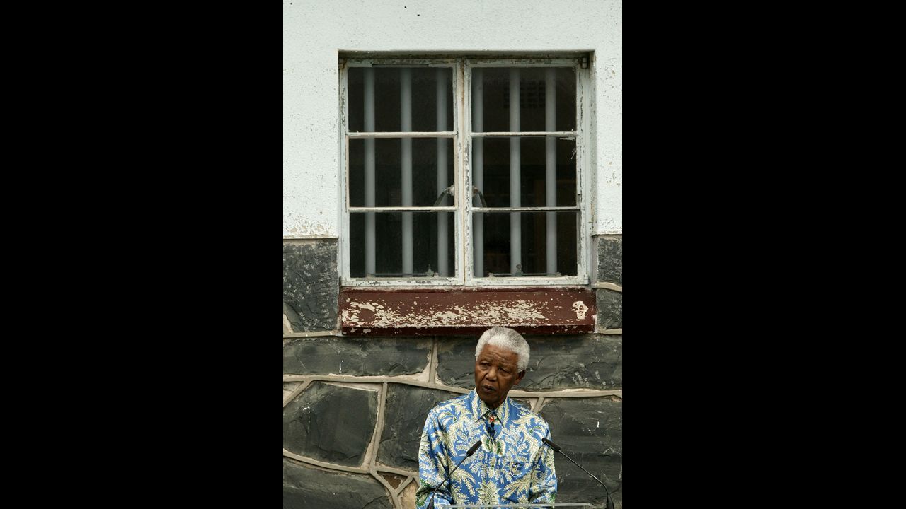 Nelson Mandela speaks outside his former prison cell during a press conference in 2003 on Robben Island, off the coast of Cape Town, South Africa. From the mid-1960s through 1991, the island served as a maximum-security prison, mostly housing offenders of political offenses. Mandela spent 18 of his 27 years in prison on Robben Island. From 1964 to 1982, Mandela was incarcerated at Robben Island Prison in the cell shown. In 1990, he was freed.