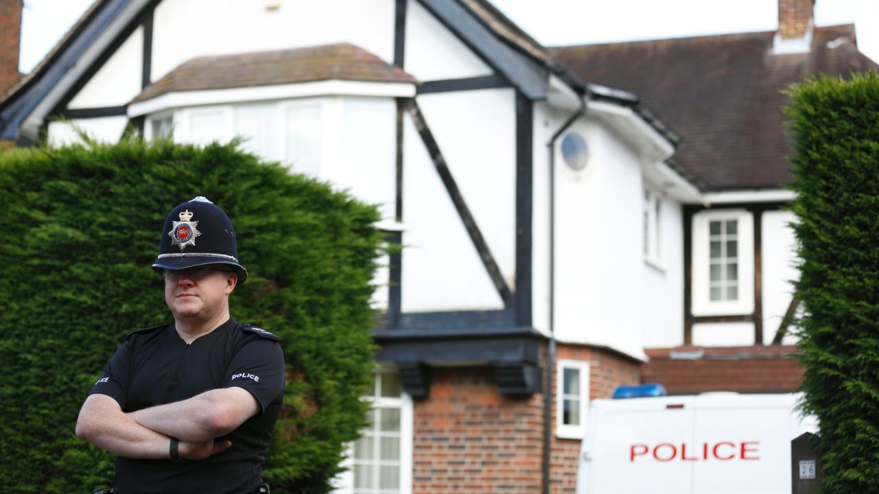 A policeman stands outside the home of Saad and Ikbal al-Hilli in Claygate, in Surrey, south-east England, on September 14, 2012.