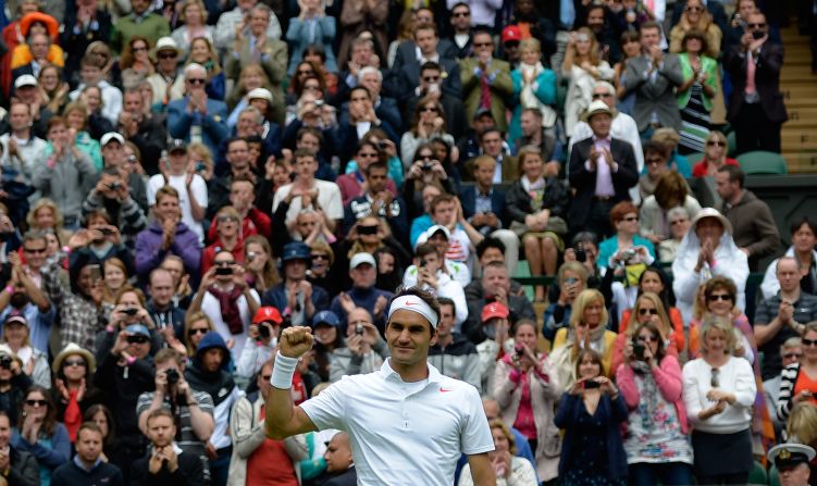 Switzerland's Roger Federer celebrates after defeating Romania's Victor Hanescu 6-3, 6-2, 6-0 during their men's first-round match on June 24.