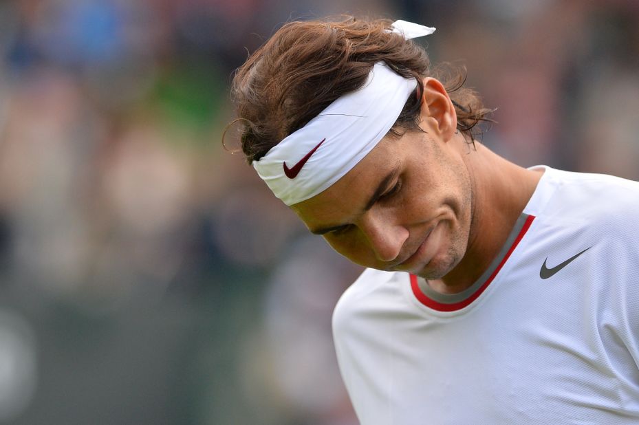 Nadal has also suffered hard times at Wimbledon. Here he reacts after a point in a defeat against Belgium's Steve Darcis in the first round of Wimbledon 2013. It was his earliest grand slam exit to date. 