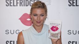 Russian tennis star Maria Sharapova poses with packets of her new candy brand called 'Sugarpova' in Selfridges, central London on June 20, 2013. AFP PHOTO / WILL OLIVERWILL OLIVER/AFP/Getty Images. S023335483