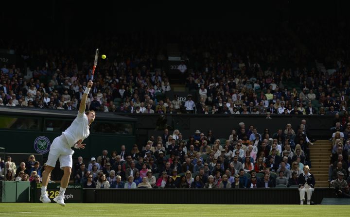 Britain's Andy Murray serves against Germany's Benjamin Becker during their first-round match on the first day of the Wimbledon Lawn Tennis Championships in London on Monday, June 24.