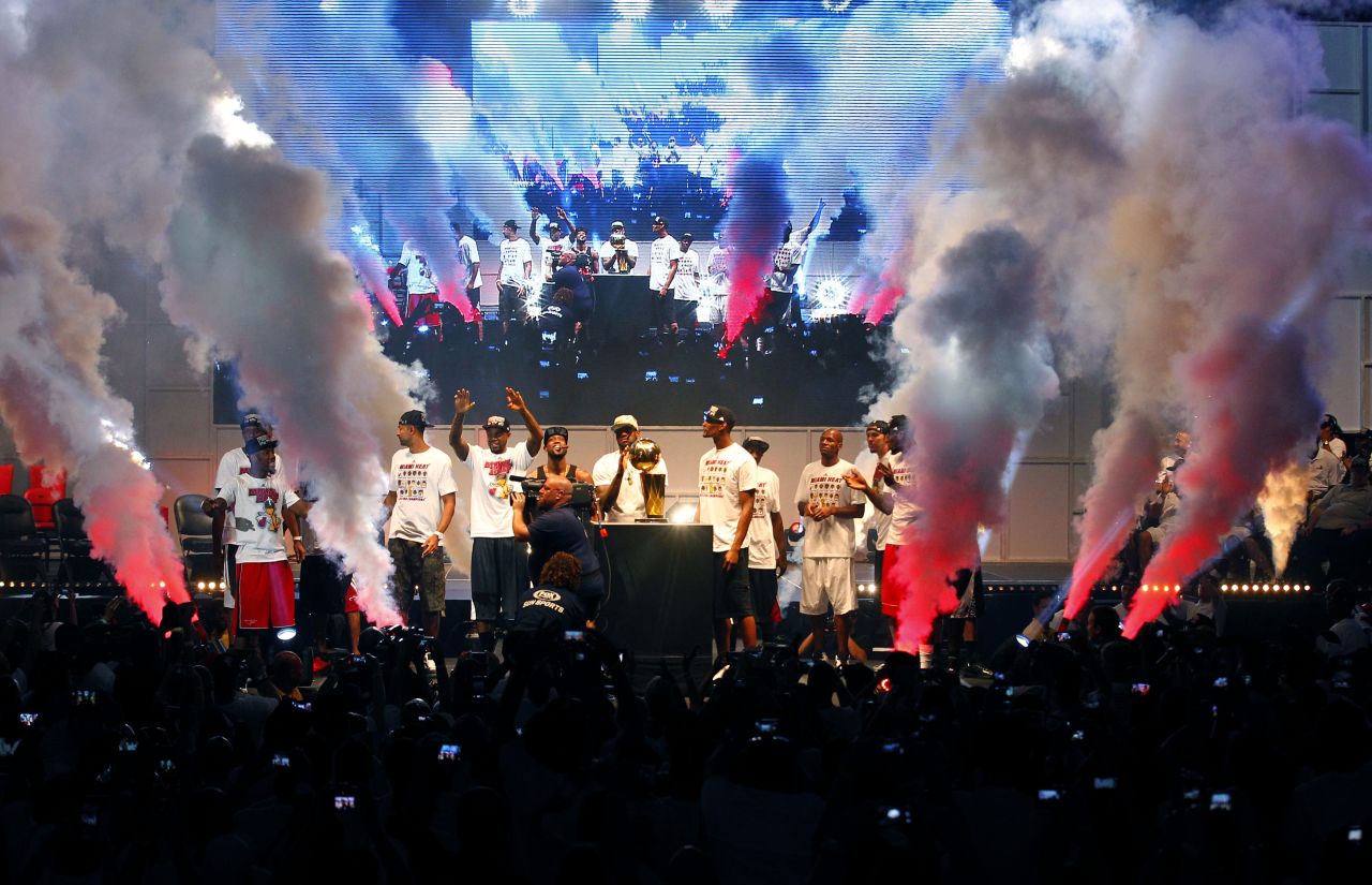 Members of the Miami Heat take the stage at a party at the American Airlines Arena after the team's championship parade in Miami on Monday, June 24. Players and fans were celebrating the Heat's second consecutive NBA title.