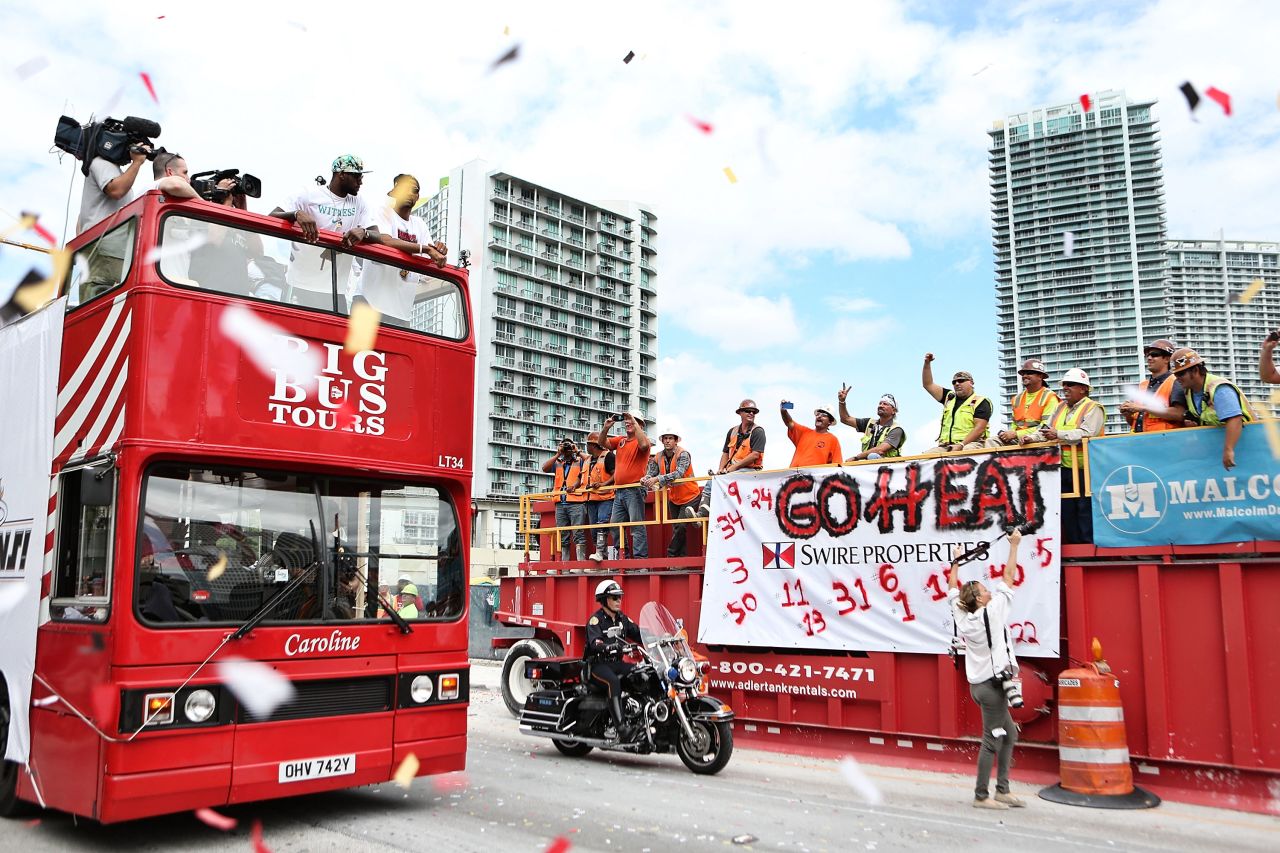 Heat players stand atop the double-decker bus. The team defeated the San Antonio Spurs in the NBA Finals.