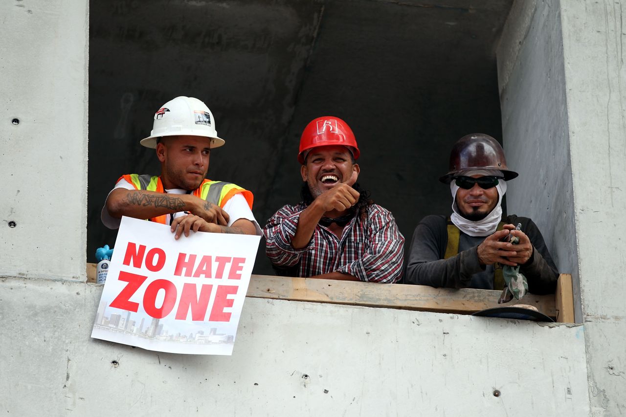 Fans hold "No Hate Zone" signs as members of the Miami Heat make their way through the city.