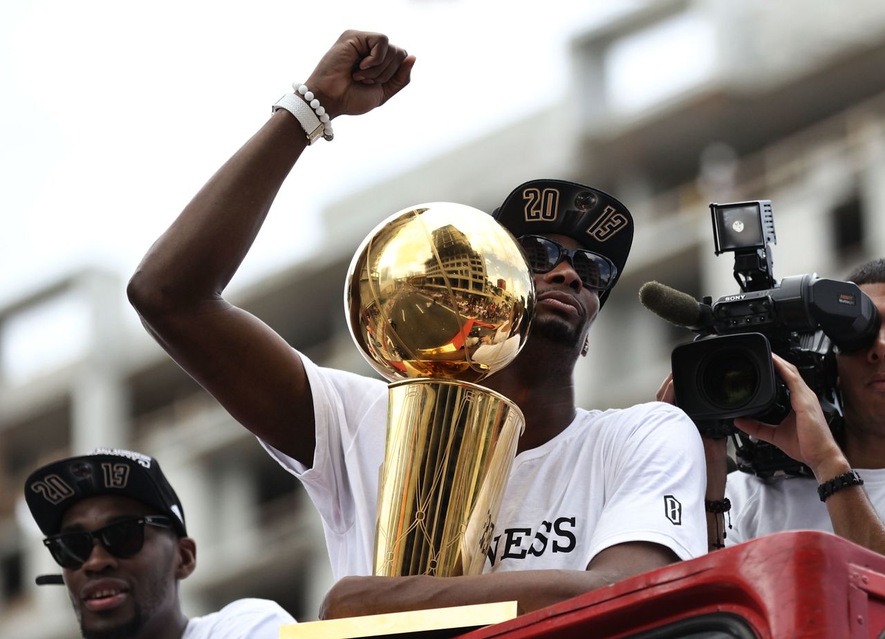 Chris Bosh holds the Larry O'Brien NBA Championship trophy during the victory parade.