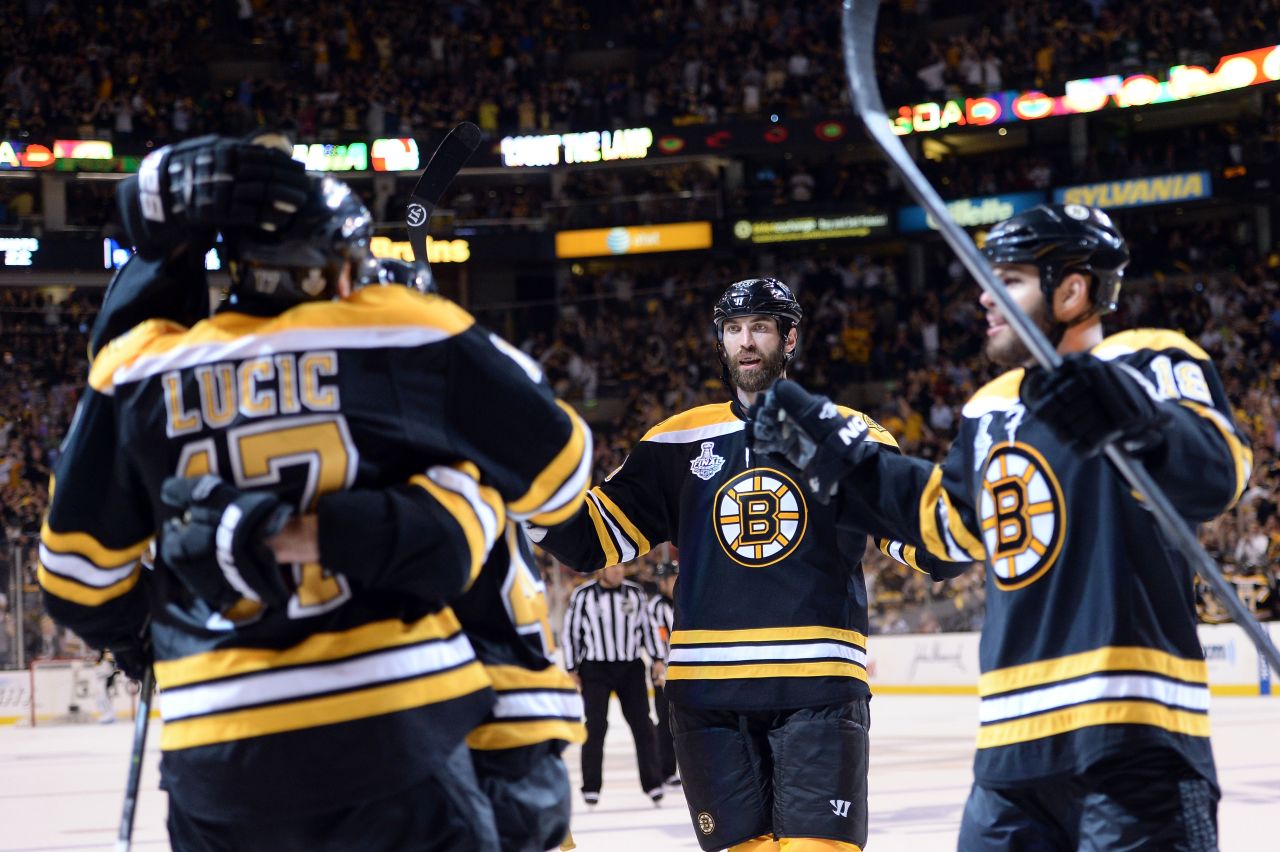 Milan Lucic of the Boston Bruins, left, celebrates with his teammates after scoring a goal in the third period.