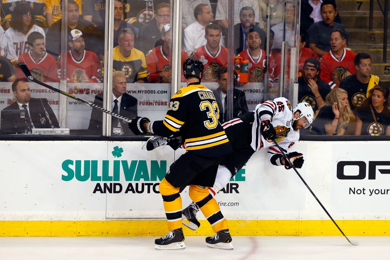 Boston's Zdeno Chara checks Chicago's Viktor Stalberg.