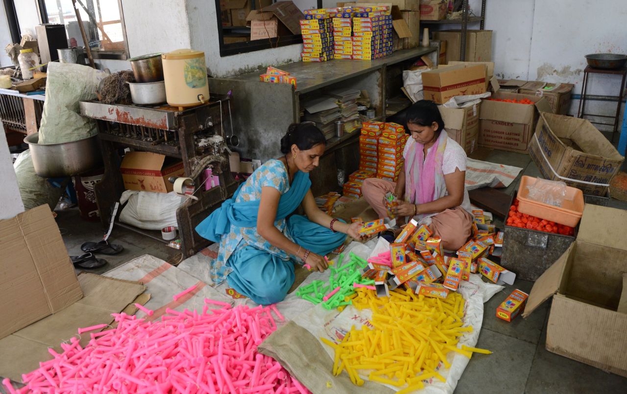 Workers pack candles at a factory in Ahmedabad, Gujarat state, on June 24. Candles are in great demand during India's monsoon season as heavy rains cause electricity blackouts.