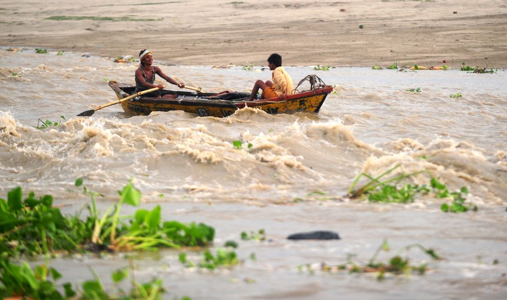 Boatmen navigate a fast-moving river in Allahabad, Uttar Pradesh state, on June 24.