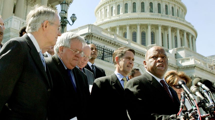 WASHINGTON - MAY 02:  U.S. Representative John Lewis (D-GA) (R) speaks while flanked by Senate Minority Leader Harry Reid (D-NV) (L), House Speaker Dennis Hastert (R-IL) (2nd-L), Senate Majority Leader Bill Frist (R-TN) (C) and other officials during a media conference on Capitol Hill May 2, 2006 in Washington, DC. The bipartisan House and Senate officials met to voice support for legislation to reauthorize the Voting Rights Act for an additional 25 years.  (Photo by Mark Wilson/Getty Images)