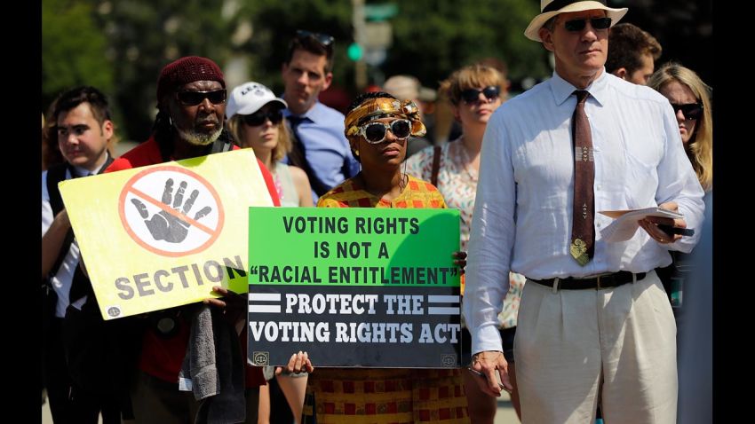 WASHINGTON, DC - JUNE 25:  Supporters of the Voting Rights Act listen to speakers discussing today's rulings outside the U.S. Supreme Court building on June 25, 2013 in Washington, DC. The court ruled that Section 4 of the Voting Rights Act, which aimed at protecting minority voters, is unconstitutional. The high court convened again today to rule on some high profile decisions including two on gay marriage and one on voting rights.  (Photo by Win McNamee/Getty Images)