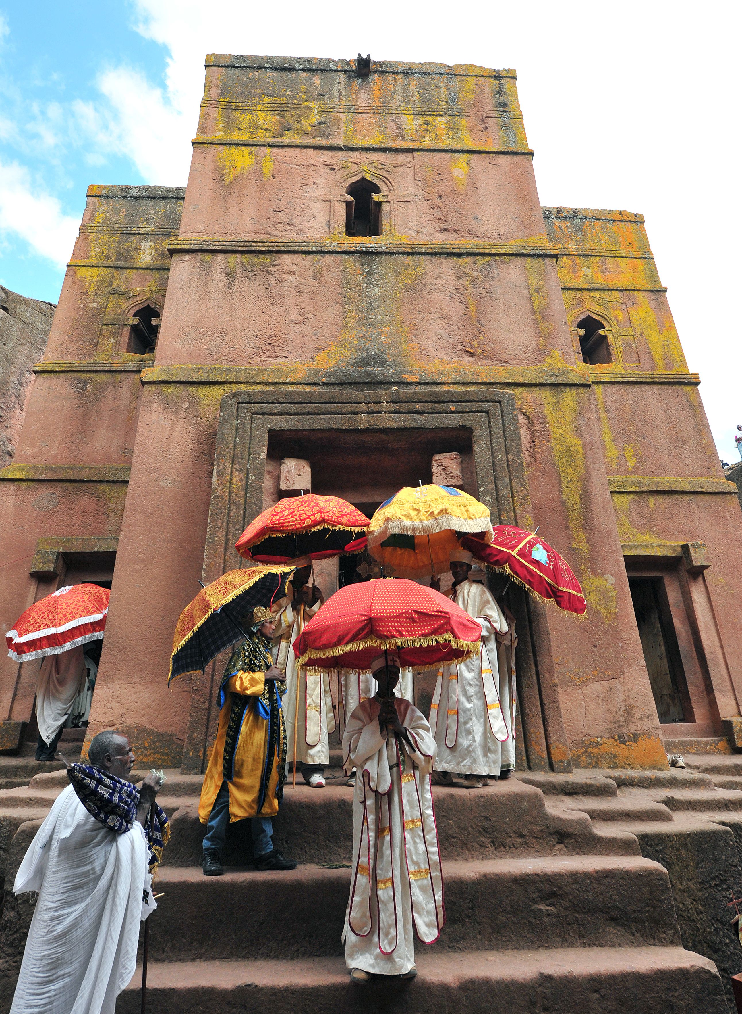 Priest in Bet Danaghel Church holding the Cross of King Lalibela. The  rock-hewn churches of Lalibela make it one of the greatest  Religio-Historical sites not only in Africa but in the Christian