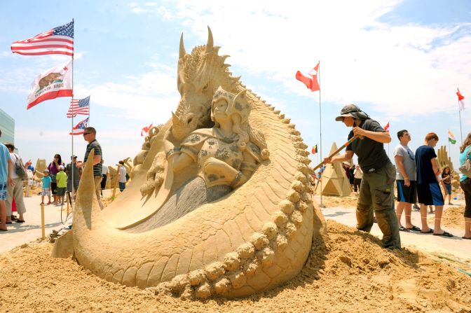 Karen Fralich of Ontario, Canada, tends to her 1st place sculpture in the singles division at the 2013 <a href="http://www.worldchampionshipofsandsculpting.com/" target="_blank" target="_blank">World Championship of Sand Sculpting</a> in Atlantic City, New Jersey. It's titled, "Amazon's Pet." Click through the gallery for more amazing sand sculptures.