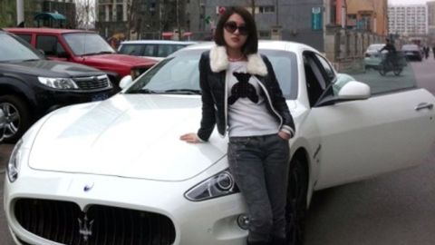 This photo posted by Guo Meimei on the Internet in 2011 shows her posing with a fancy sports car.
