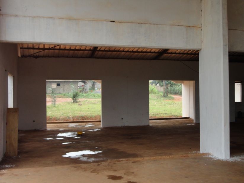 Puddles litter the inside of unfinished buildings in the complex on the outskirts of Yaounde, where squatters and police occupy a building originally built for young sportsmen.