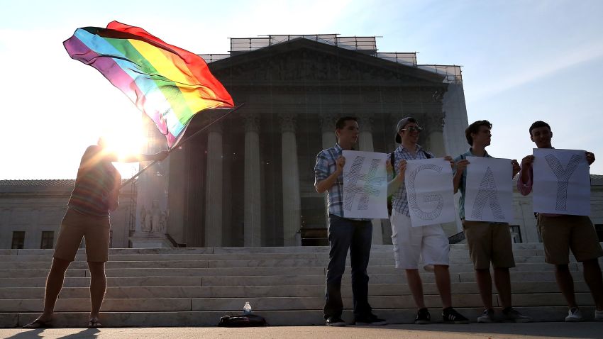 WASHINGTON, DC - JUNE 26: Gay rights activists gather in front of the U.S. Supreme Court building, June 26, 2013 in Washington DC. Today the high court is expected to rule on California's Proposition 8, the controversial ballot initiative that defines marriage as between a man and a woman (Photo by Mark Wilson/Getty Images)