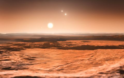 Scientists announced in June 2013 that three planets orbiting star Gliese 667C could be habitable. This is an artist's impression of the view from one of those planets, looking toward the parent star in the center. The other two stars in the system are visible to the right.