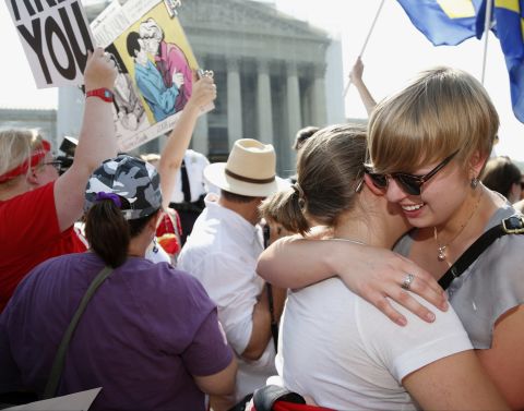 American University students Sharon Burk, left, and Molly Wagner embrace outside the Supreme Court.
