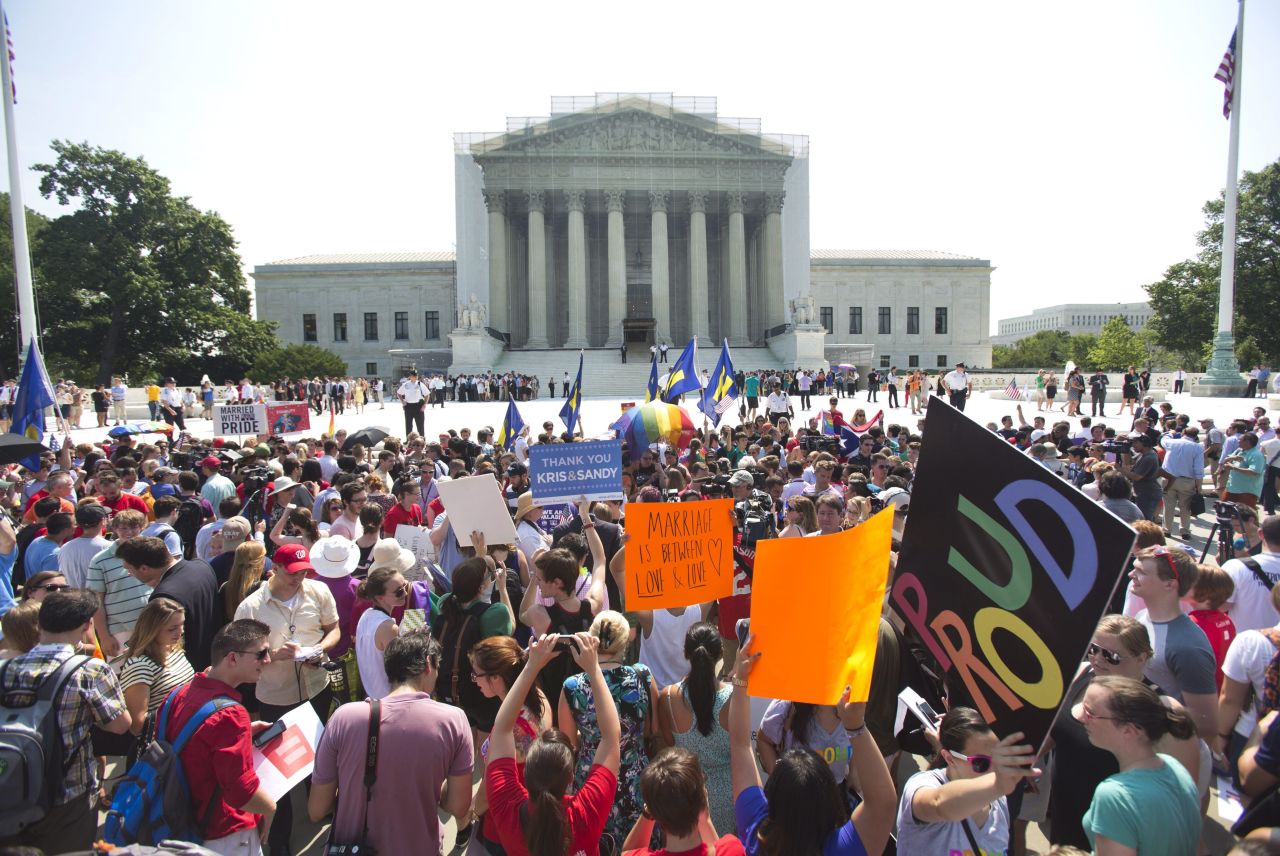 A crowd of people outside the Supreme Court in Washington react to the rulings.