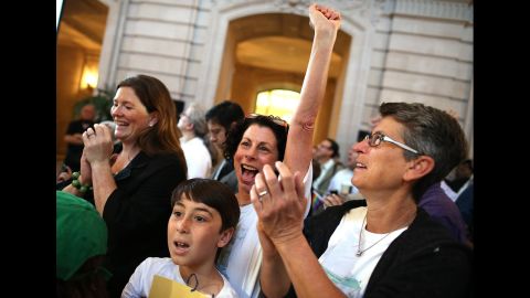 Sue Rochman, center, and Robin Romdalvik celebrate with their son, Maddox Rochman-Romdalvik, at City Hall in San Francisco.