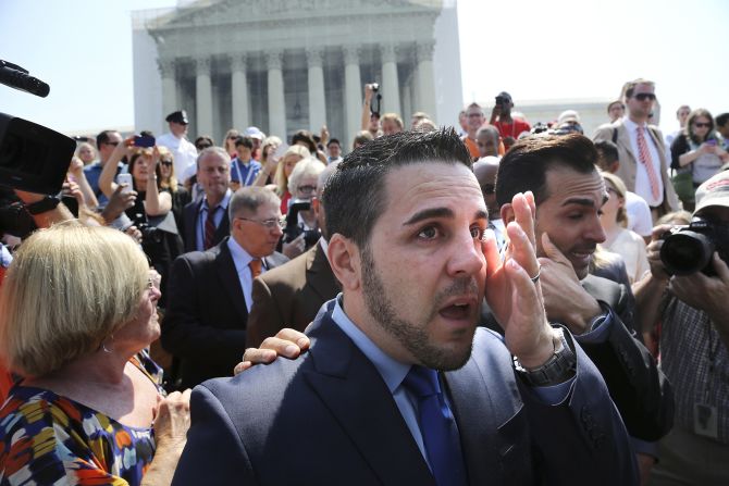 Jeff Zarrillo, center, and Paul Katami, right, plaintiffs in the California case against Proposition 8, wipe away tears after departing the Supreme Court in Washington. <a href="index.php?page=&url=http%3A%2F%2Fwww.cnn.com%2Fvideo%2F%3F%2Fvideo%2Fpolitics%2F2013%2F06%2F26%2Fsot-dc-scotus-prop-8-proposal-katami-zarrillo.cnn">Katami proposed to Zarrillo</a> on national news after the ruling.