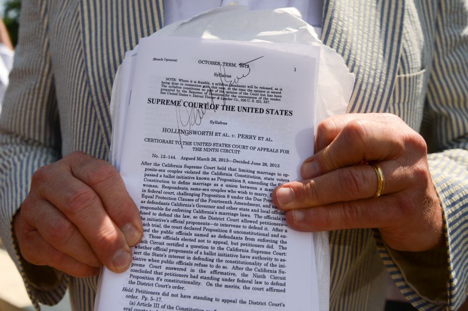 Erin Raskauskas Jr. shows off the autograph he got from attorney David Boies on a copy of the Proposition 8 ruling outside of the Supreme Court in Washington.