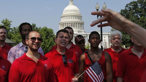 With the Capitol in the background, the Gay Men's Choir of Washington performs outside of the Supreme Court in Washington.