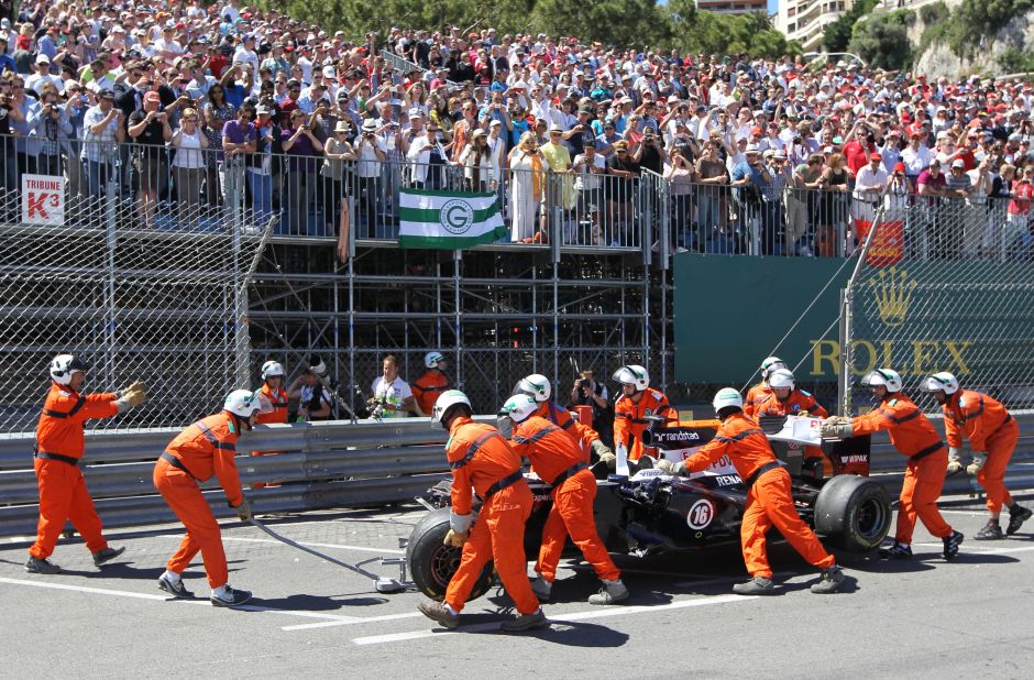 The marshals are on hand to remove debris from track -- and push cars away to safety. Here they help Pastor Maldonado after his Williams comes to a halt in Monaco.