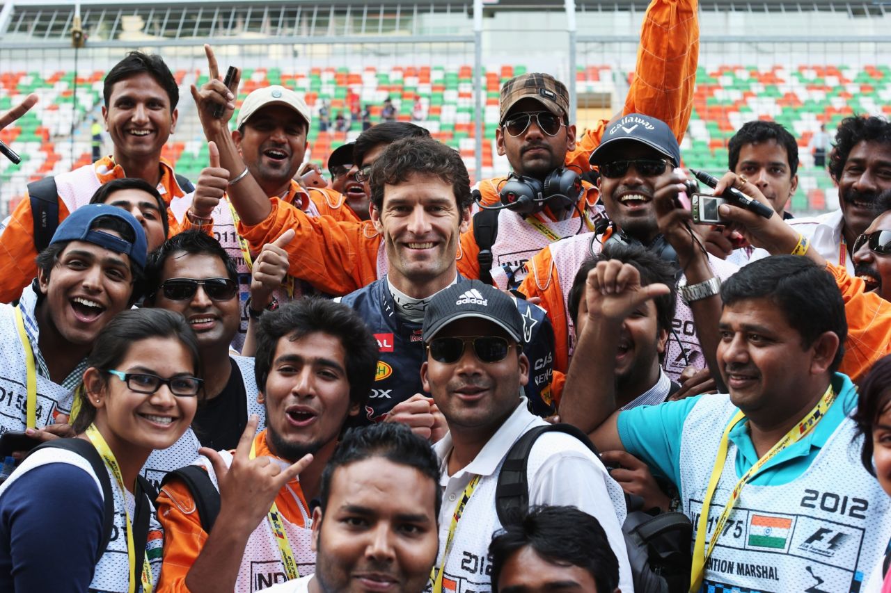 F1's global marshals are as integral to the sport as the drivers. Here some of the Indian Grand Prix marshals meet Red Bull racer Mark Webber in 2012.