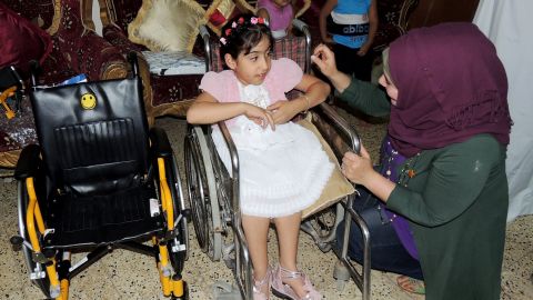 Noor al-Zahra Haider, who has spina bifida, receives a new pediatric wheelchair  from America this week in Baghdad.
