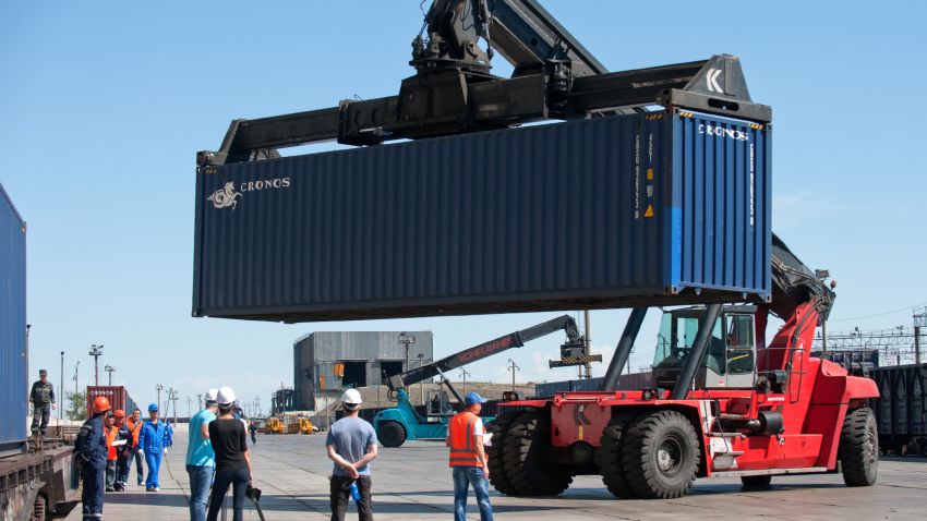 Due to a change in track gauge from 'normal' (or 1435mm) in China to 'wide' (or 1520mm) in Kazakhstan, the cargo containers must be transferred to new rolling stock.